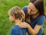 Lyme disease prevention for children A woman examining a young child’s hair for ticks after outdoor play.