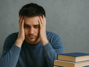 Important Resources for Depression Young man sitting alone looking thoughtful while seeking resources for depression