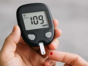 What is Considered Alarming in Prediabetes Blood Sugar Doctor holding glucose monitor discussing results with a patient