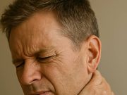 Why are the Causes of Chronic Pain? Adult male experiencing chronic pain at home.