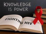 Fighting HIV with Knowledge: The Power of Education in the Global Response Public health educator discussing HIV facts in a small group