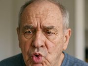 What is Tardive Dyskinesia? adult showing symptoms of tardive dyskinesia at home.