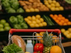 Grocery Shopping Advice for Diabetes Patients Woman reading food label in grocery store for diabetic diet.