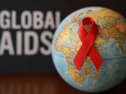 Challenges with the Global Aids Epidemic Doctors and researchers discussing global AIDS strategy at a desk.